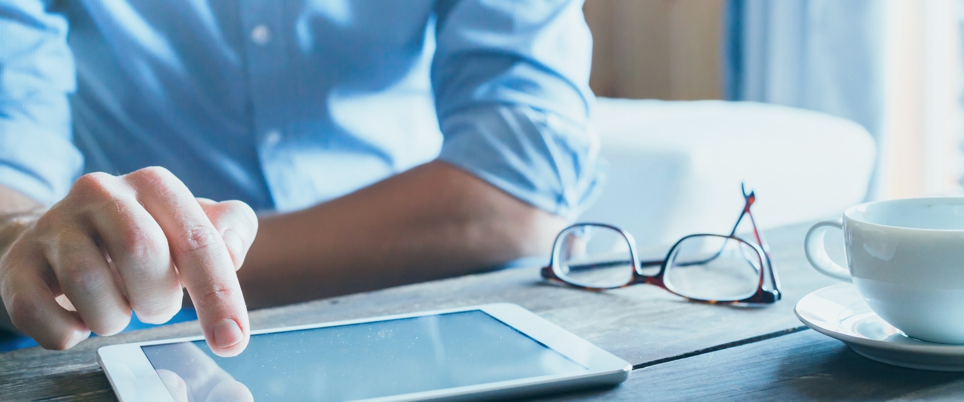 man using digital tablet computer, close up of the hand, business and technology background with copy space