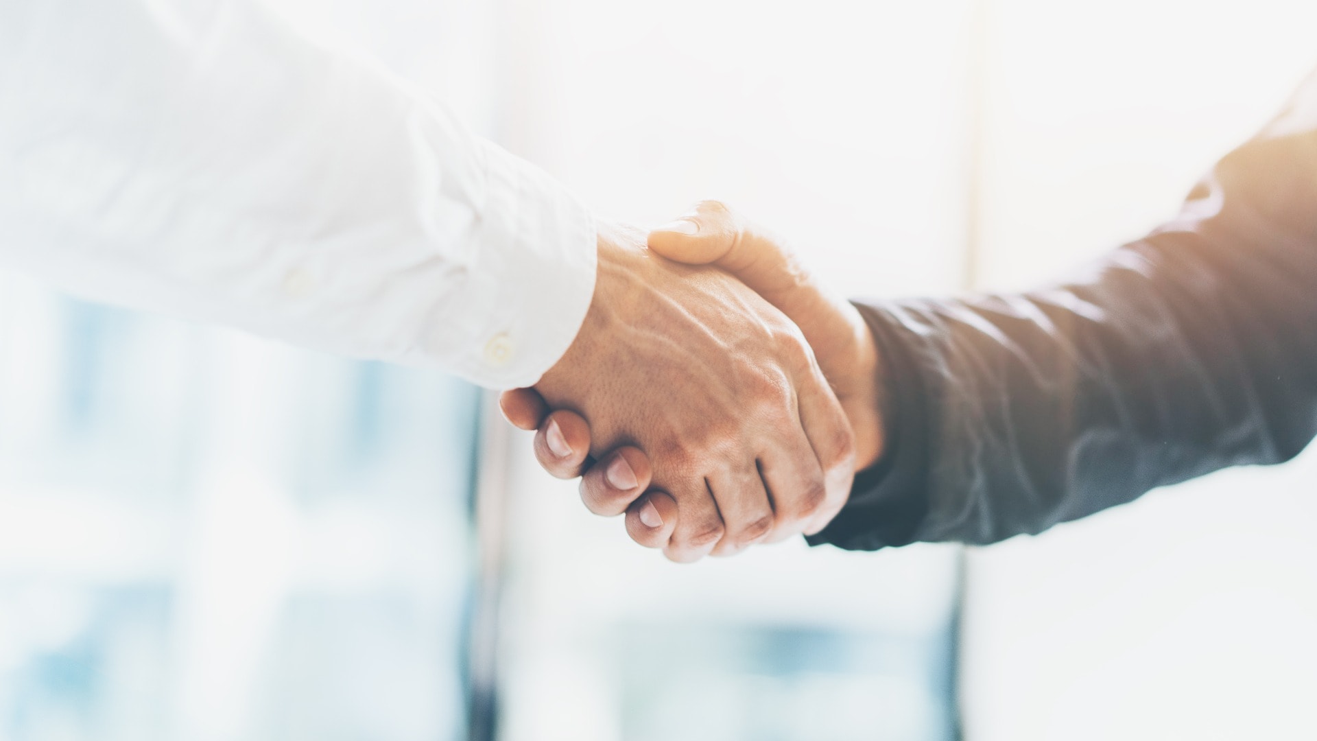 Business partnership meeting. Picture businessmans handshake. Successful businessmen handshaking after good deal. Horizontal, blurred background